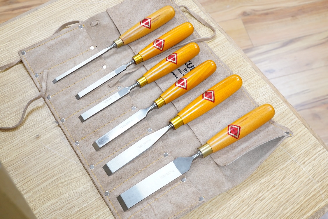 Five woodworking chisel sets, all in leather rolls, including an unused nine piece set by Robert Sorby, a six piece set by Henry Taylor, and three other sets showing some wear